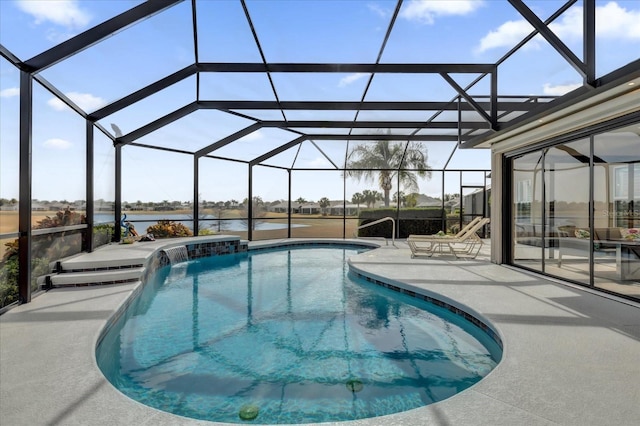 view of swimming pool featuring pool water feature, a patio, a water view, and glass enclosure