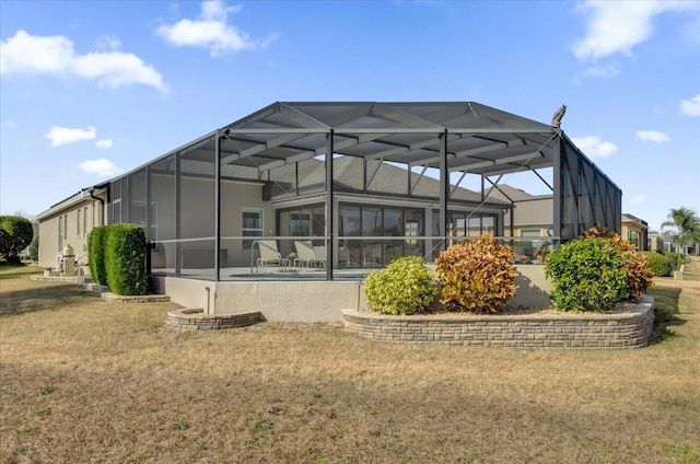 rear view of property featuring a lanai, a yard, and a patio area