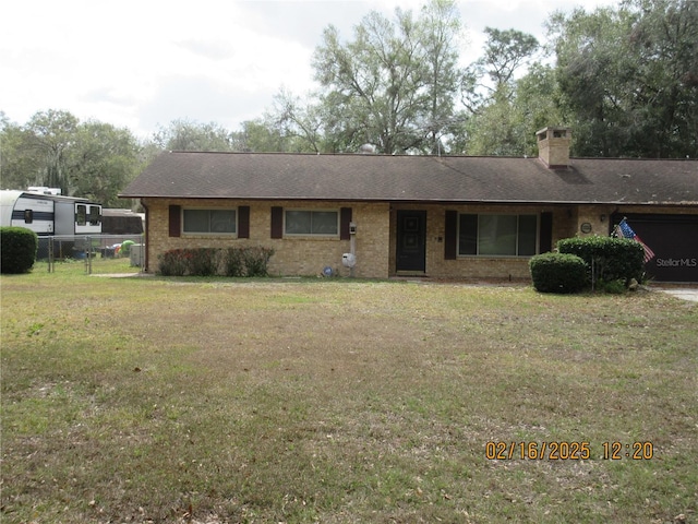 ranch-style house with brick siding, a shingled roof, fence, a chimney, and a front yard