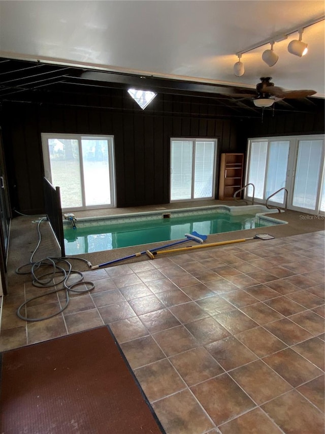 indoor pool with a ceiling fan