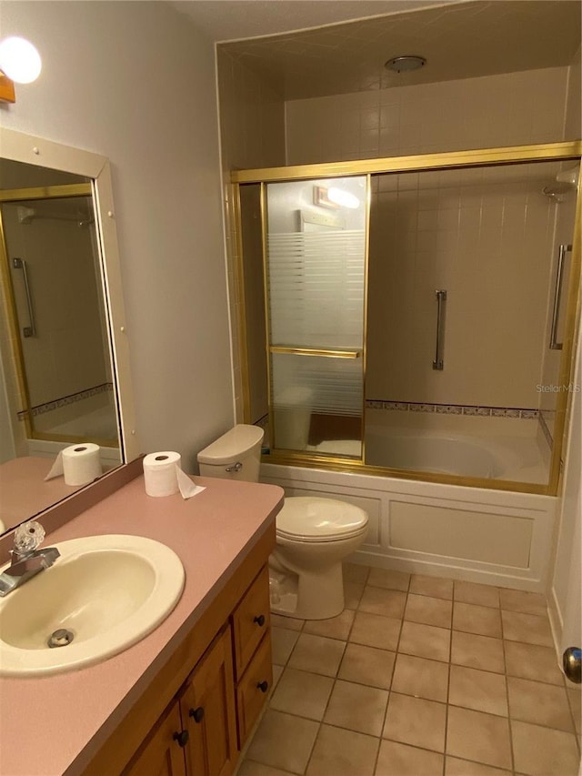 full bath featuring toilet, shower / bath combination with glass door, vanity, and tile patterned floors