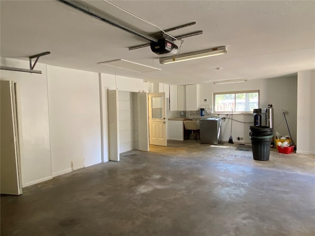 garage with washer / dryer, a sink, and a garage door opener