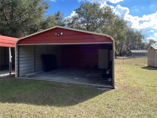 garage with a carport and fence