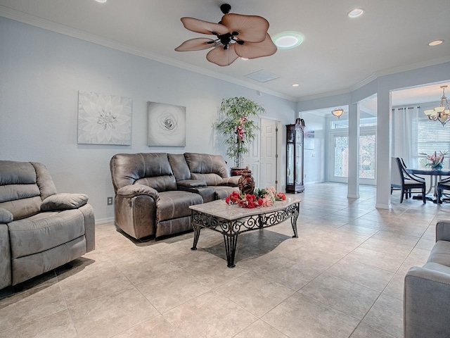 living room featuring light tile patterned floors, ceiling fan with notable chandelier, and ornamental molding