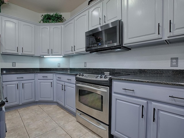 kitchen featuring light tile patterned floors and stainless steel appliances