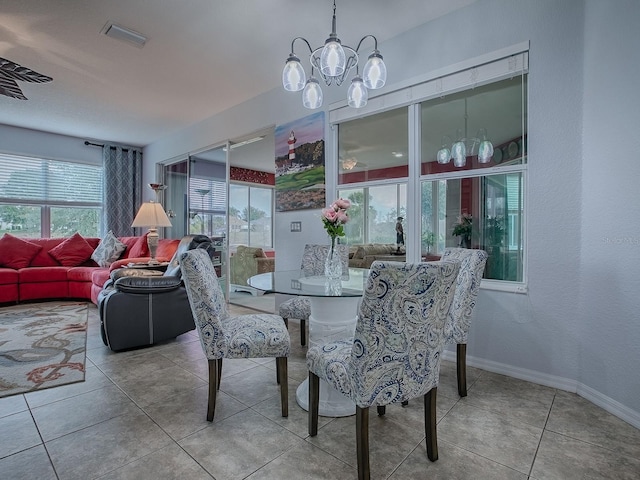 dining room with light tile patterned floors and a notable chandelier