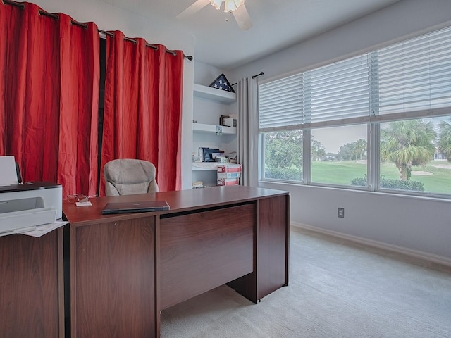 unfurnished office featuring light colored carpet and ceiling fan