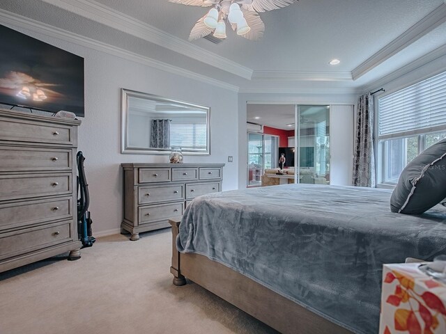 bedroom featuring ceiling fan, ornamental molding, a raised ceiling, and light carpet