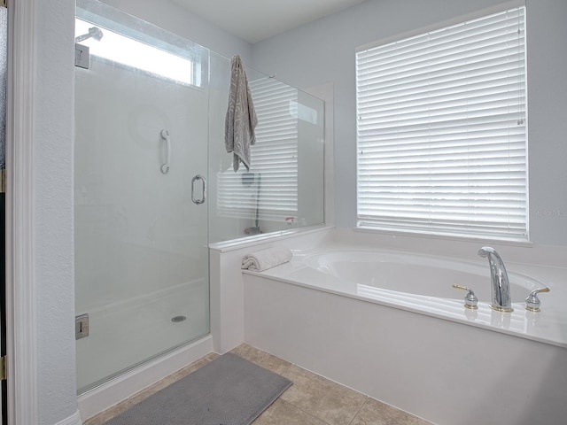 bathroom featuring tile patterned flooring and independent shower and bath