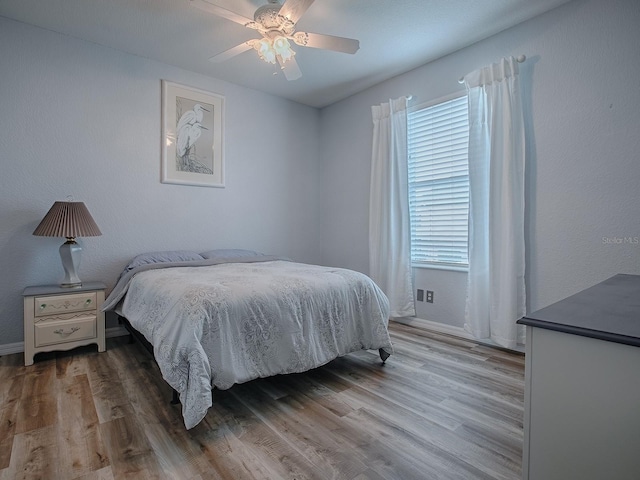 bedroom with ceiling fan and light hardwood / wood-style flooring