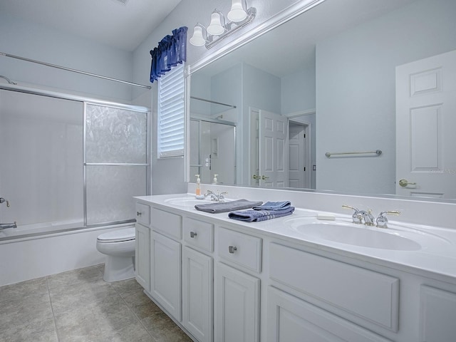 full bathroom with enclosed tub / shower combo, vanity, tile patterned floors, and toilet