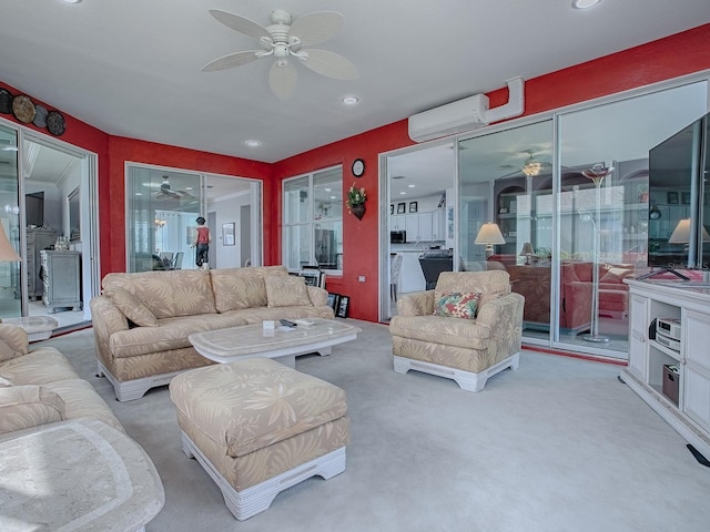 living room featuring ceiling fan, light colored carpet, and a wall unit AC