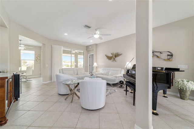 living area featuring a ceiling fan and light tile patterned flooring