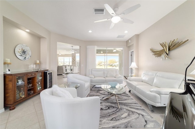 living room featuring light tile patterned floors, beverage cooler, visible vents, and recessed lighting