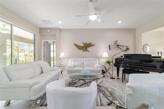 living room featuring baseboards, recessed lighting, visible vents, and a ceiling fan