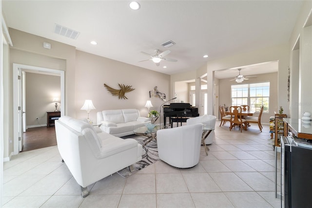 living room with a ceiling fan, recessed lighting, visible vents, and light tile patterned floors