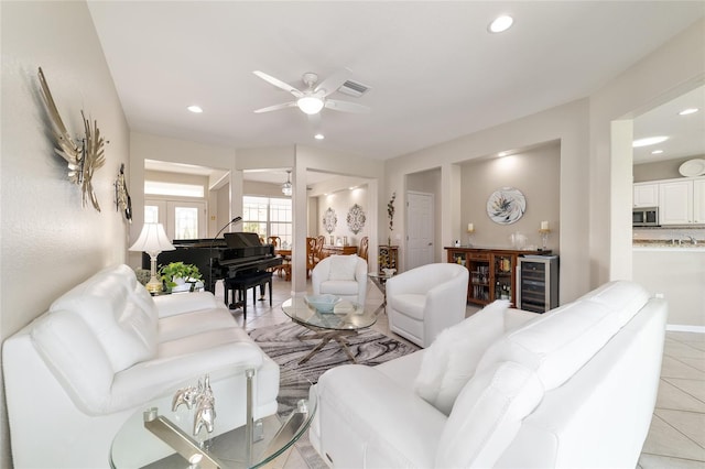 living area with light tile patterned floors, ceiling fan, wine cooler, and recessed lighting