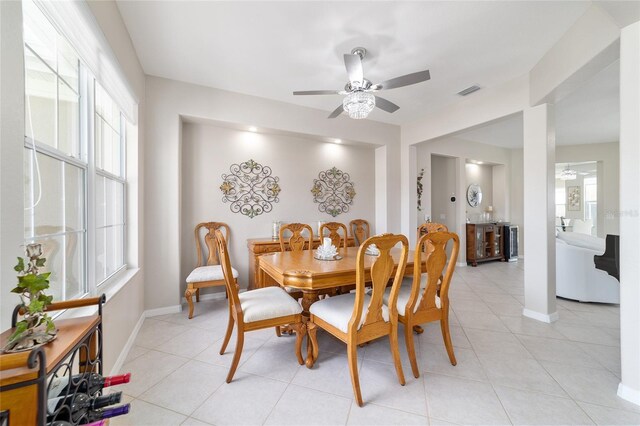 dining area with light tile patterned floors, visible vents, baseboards, and a ceiling fan