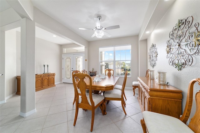 dining space with light tile patterned floors, ceiling fan, and baseboards