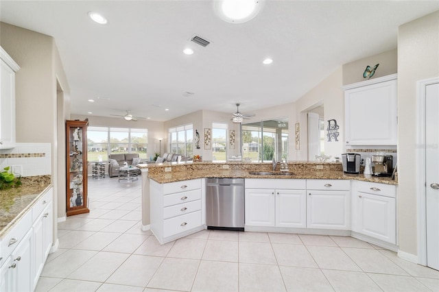 kitchen with backsplash, visible vents, a sink, and a peninsula