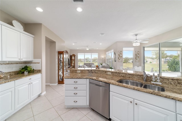 kitchen featuring light tile patterned floors, a sink, white cabinetry, dishwasher, and tasteful backsplash