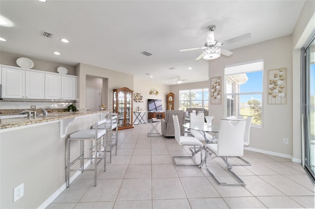 dining area featuring light tile patterned floors, baseboards, and visible vents