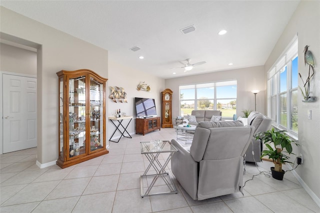 living room with light tile patterned flooring, recessed lighting, a ceiling fan, visible vents, and baseboards