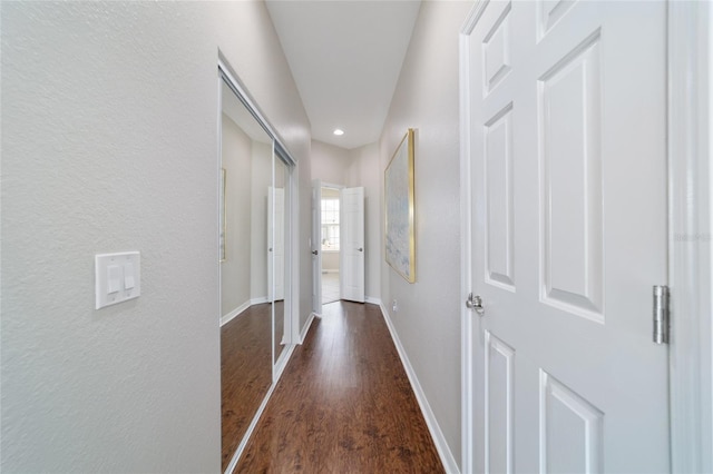 corridor with recessed lighting, baseboards, and wood finished floors