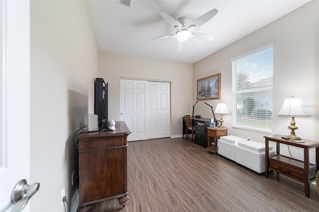 sitting room with ceiling fan, wood finished floors, visible vents, and baseboards