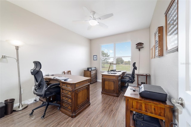 home office with ceiling fan, baseboards, and wood finished floors