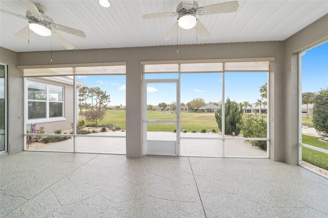 unfurnished sunroom featuring wood ceiling and ceiling fan