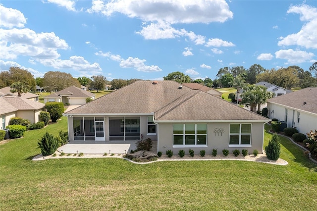 back of house with a shingled roof, a lawn, a sunroom, and stucco siding