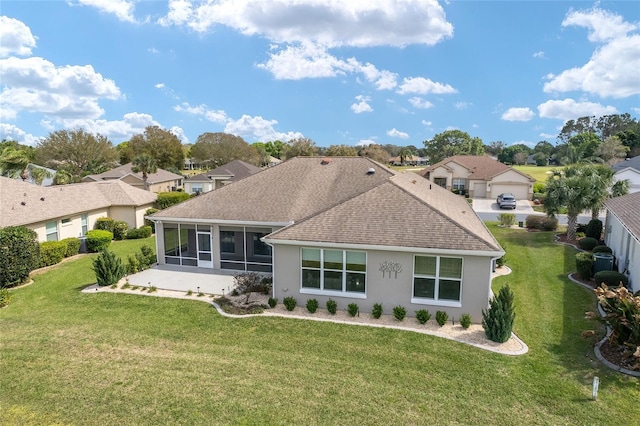 back of property with a shingled roof, a residential view, a sunroom, and a lawn