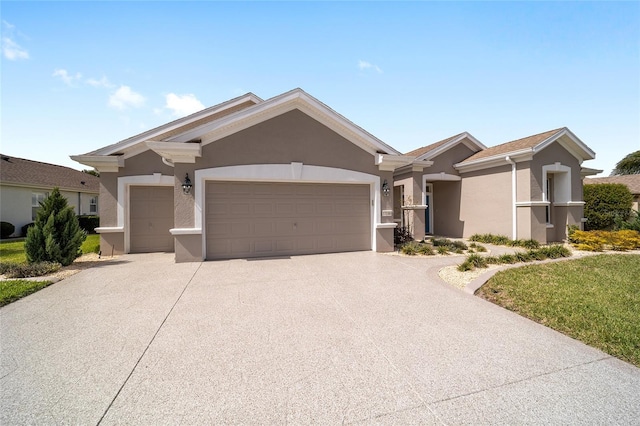 single story home featuring an attached garage, concrete driveway, and stucco siding