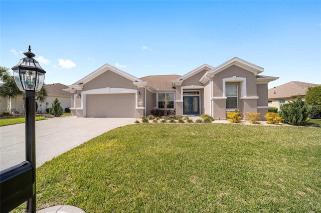 view of front facade with french doors, stucco siding, an attached garage, driveway, and a front lawn