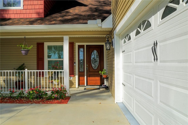 entrance to property with a garage and a porch