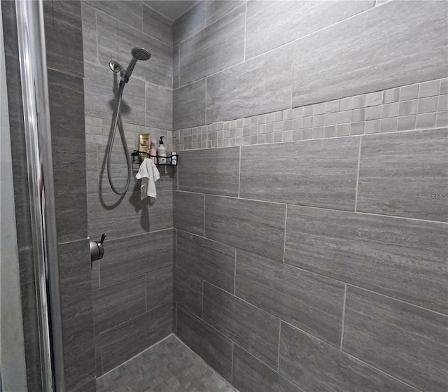 bathroom with a tile shower