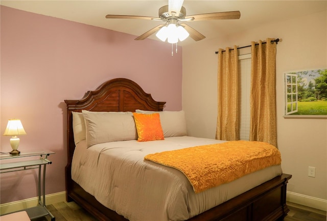 bedroom with ceiling fan and dark hardwood / wood-style flooring