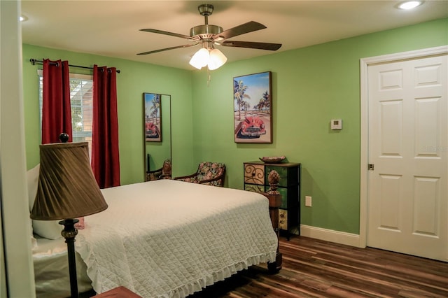 bedroom with dark wood-type flooring and ceiling fan