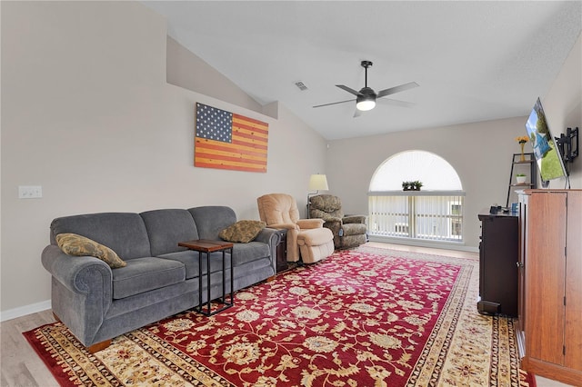 living area featuring light wood-type flooring, visible vents, baseboards, ceiling fan, and vaulted ceiling