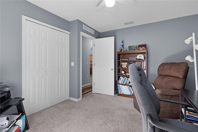 carpeted home office with visible vents, baseboards, and a ceiling fan