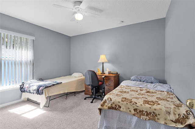 bedroom featuring a textured ceiling, carpet floors, and ceiling fan