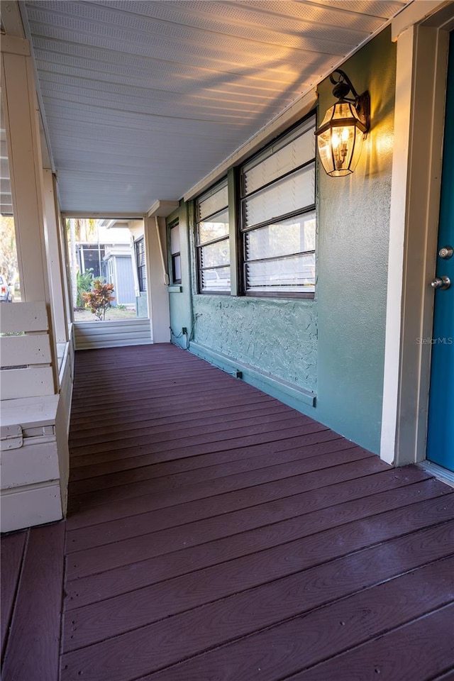 wooden terrace featuring covered porch