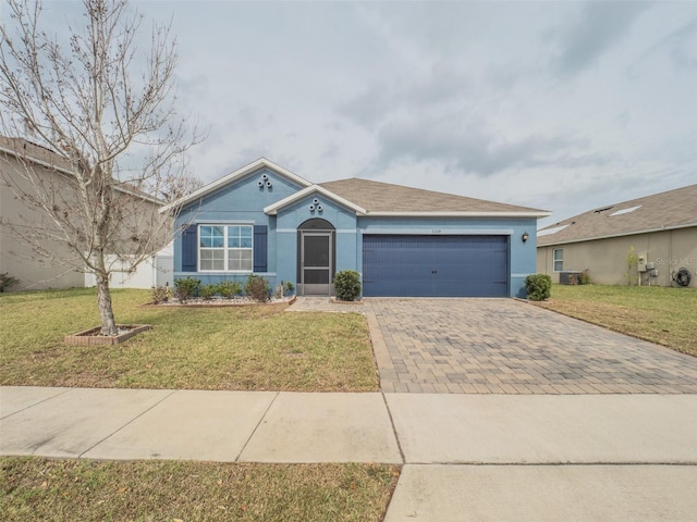 single story home featuring a garage, a front lawn, decorative driveway, and stucco siding