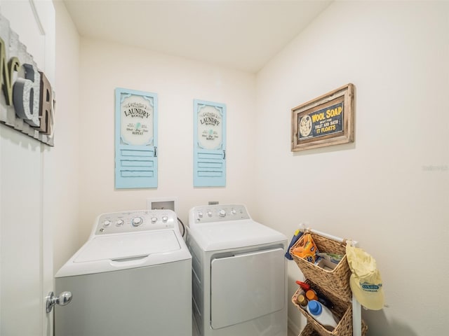 clothes washing area with laundry area and separate washer and dryer