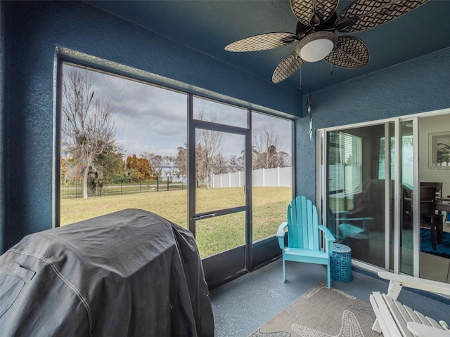 sunroom / solarium featuring ceiling fan