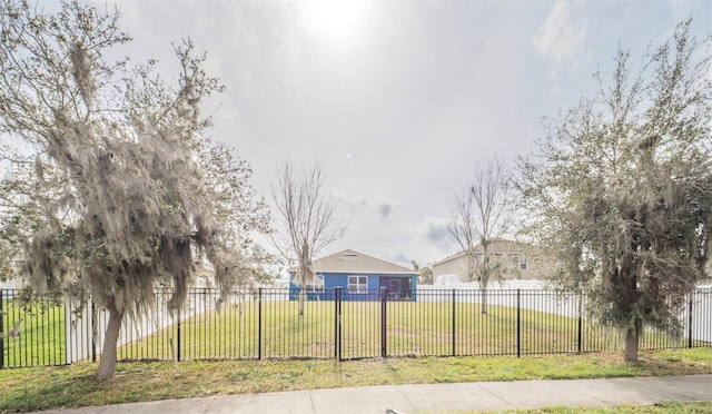 view of home's community featuring a lawn and fence private yard