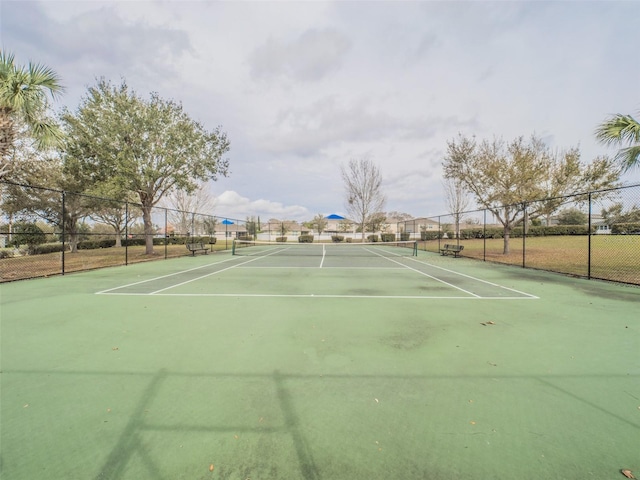 view of sport court featuring fence