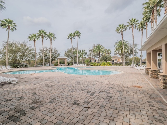 pool with a patio area and a gazebo