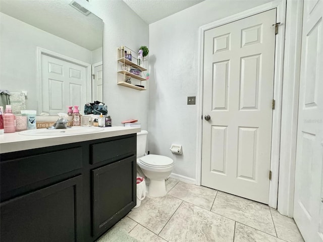 bathroom with tile patterned floors, vanity, and toilet